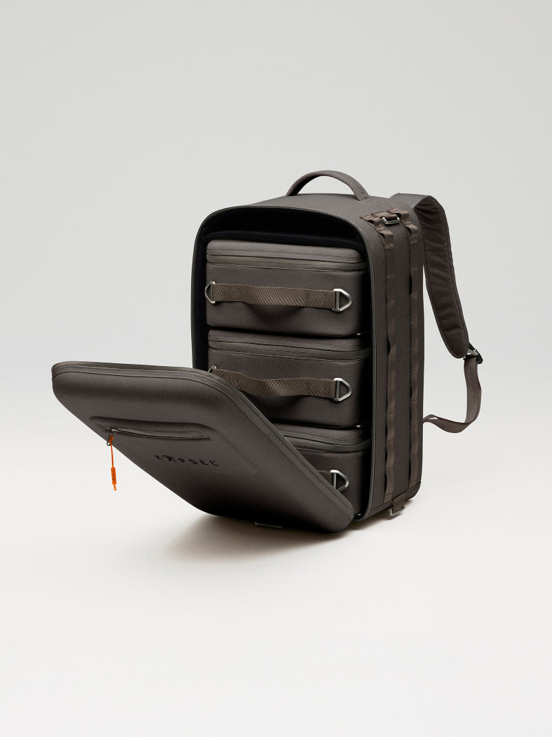 Black emergency backpack with open compartment on a light gray background