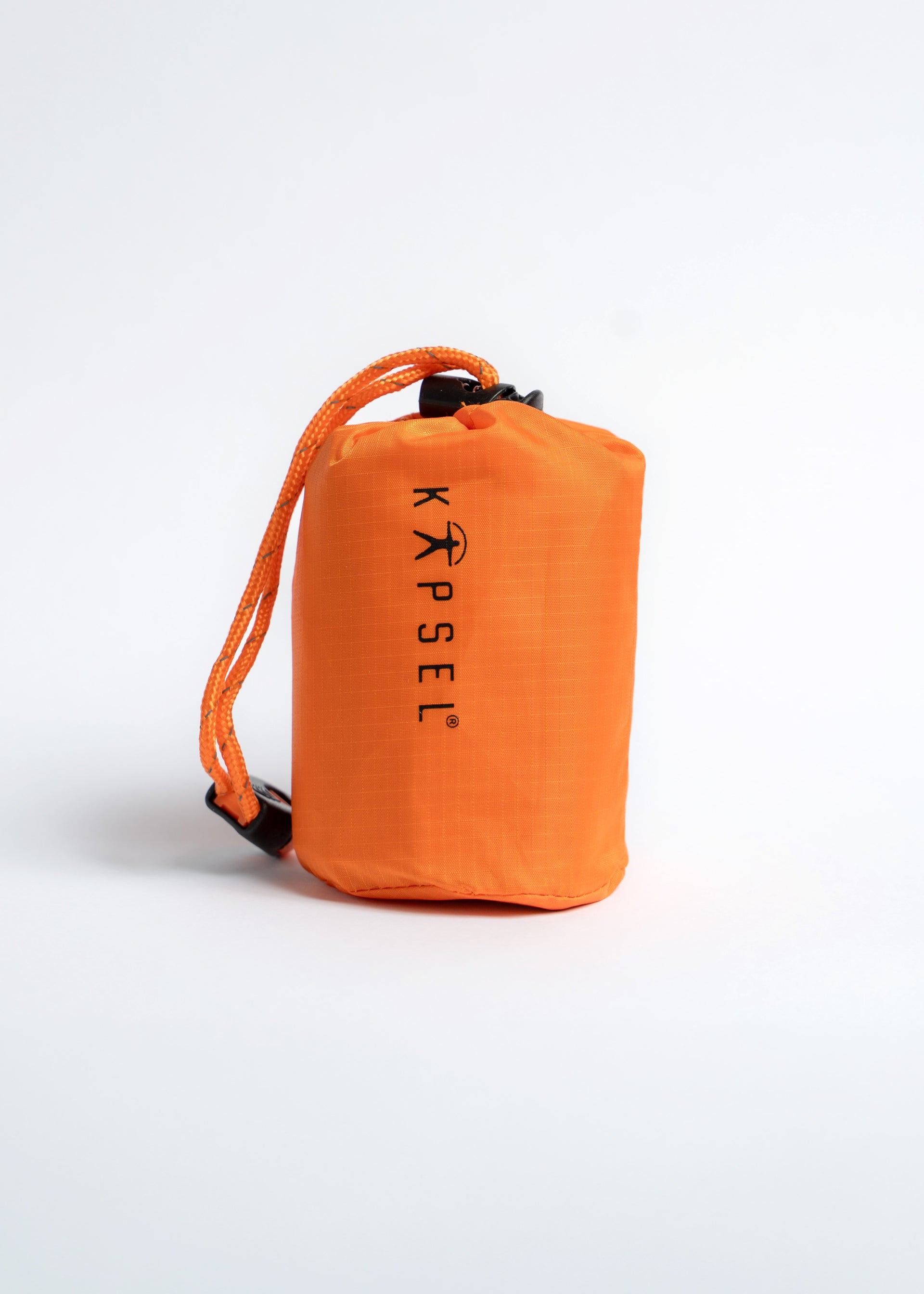 Orange Kapsel emerengy sleeping bag on a white background