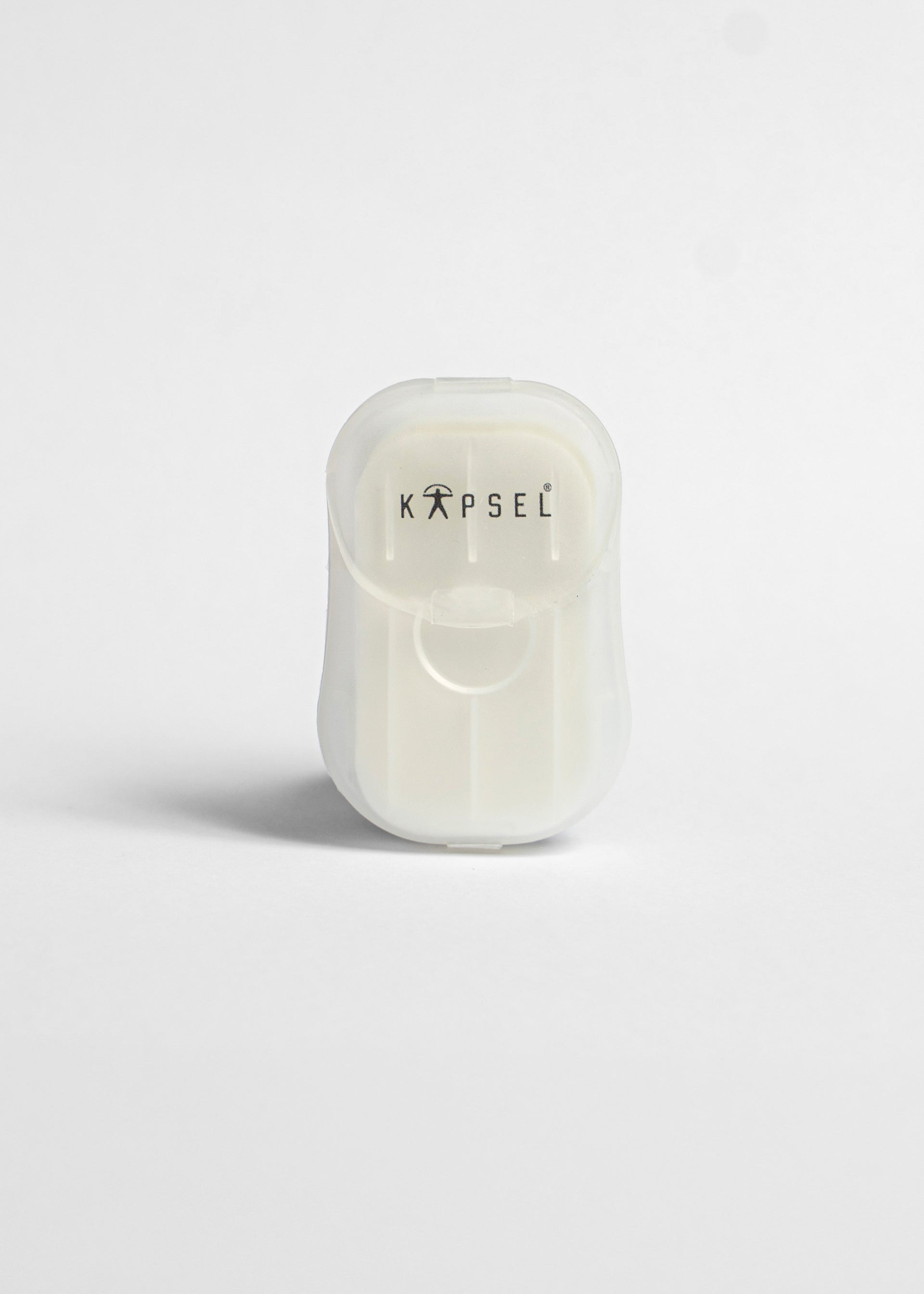 White paper soap with 'KAPSEL' branding on a light gray background
