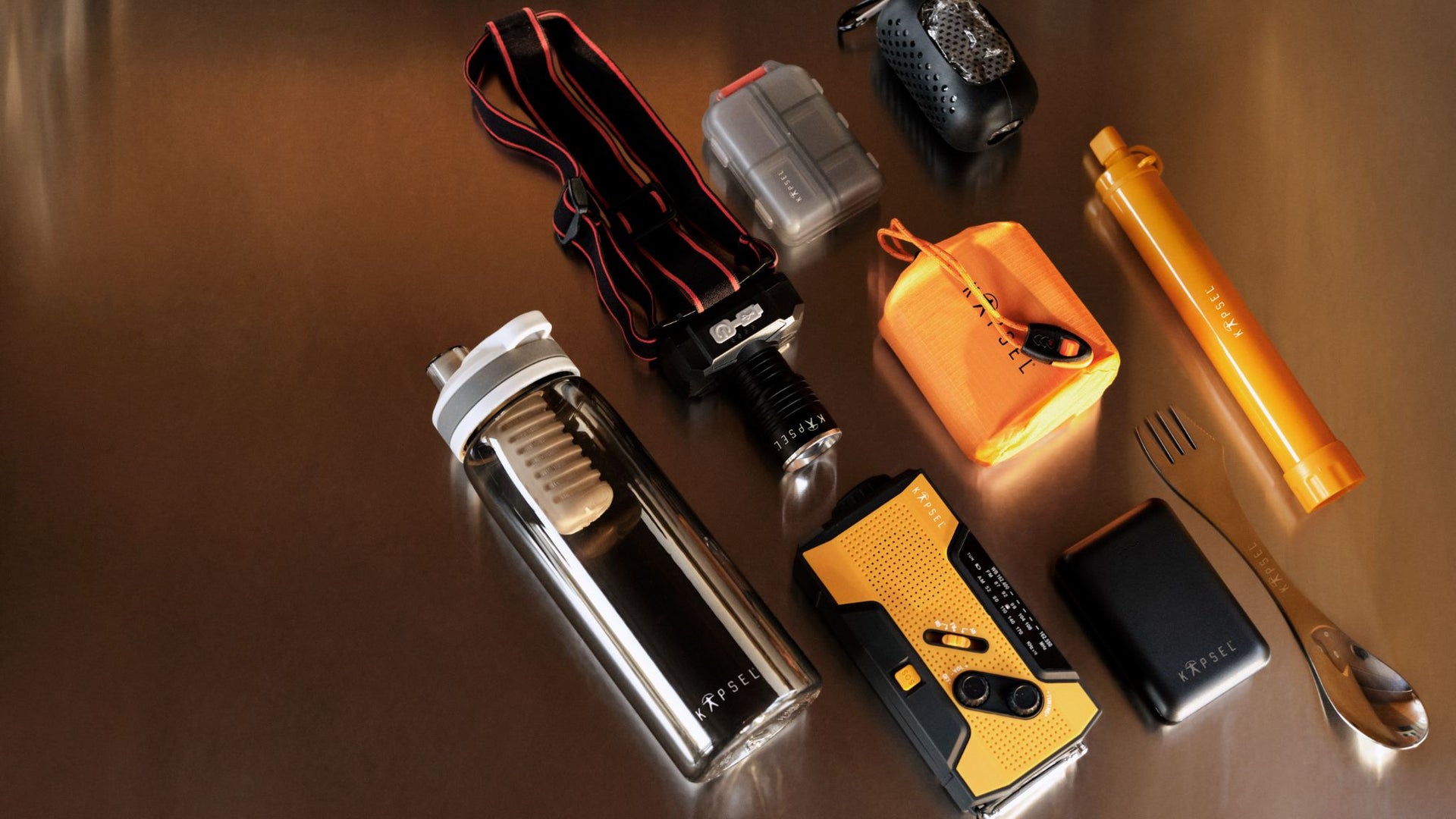 Collection of various tools and equipment on a reflective surface